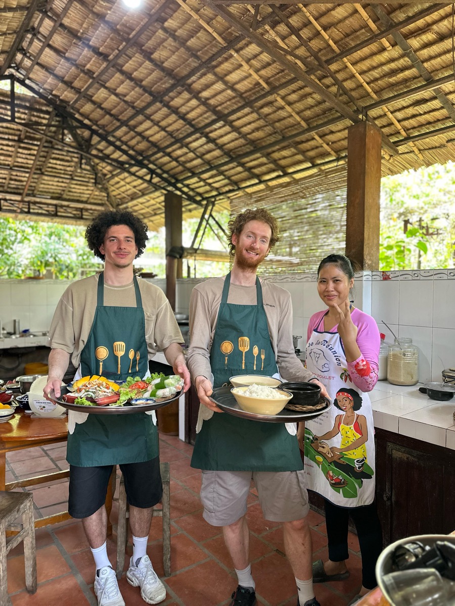 Cooking class hosts with a finished dish